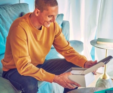 A man openingn an IQOS box.