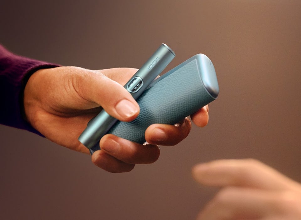 Mano sujetado dispositivo y holder de IQOS ILUMA i PRIME en Azul Brisa 
