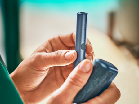 An Azure Blue IQOS ILUMA Holder and Pocket Charger.