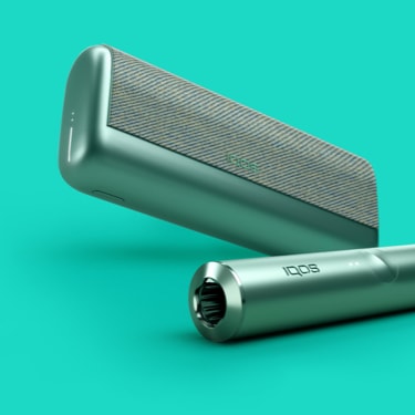 A jade green IQOS ILUMA PRIME holder and a matching device with a TEREA stick inserted.