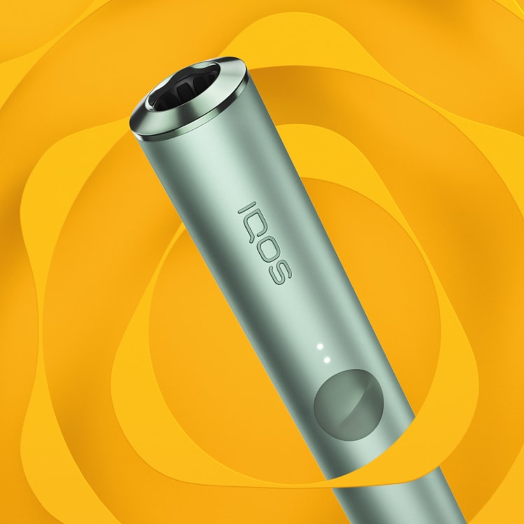 A jade green IQOS ILUMA PRIME device.